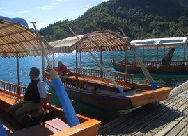 Pletna boats docked below the church